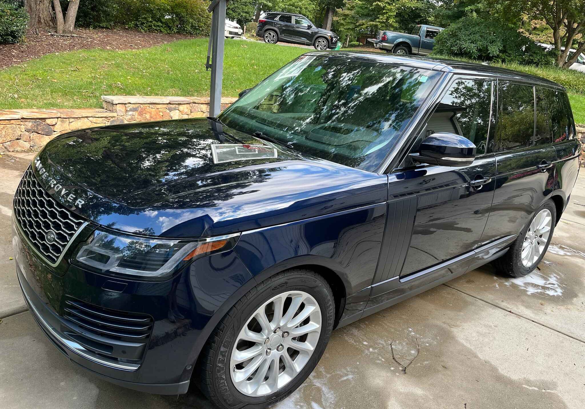 Range Rover with a mirror-like reflection after professional automotive ceramic coating in Lake Norman for superior protection.