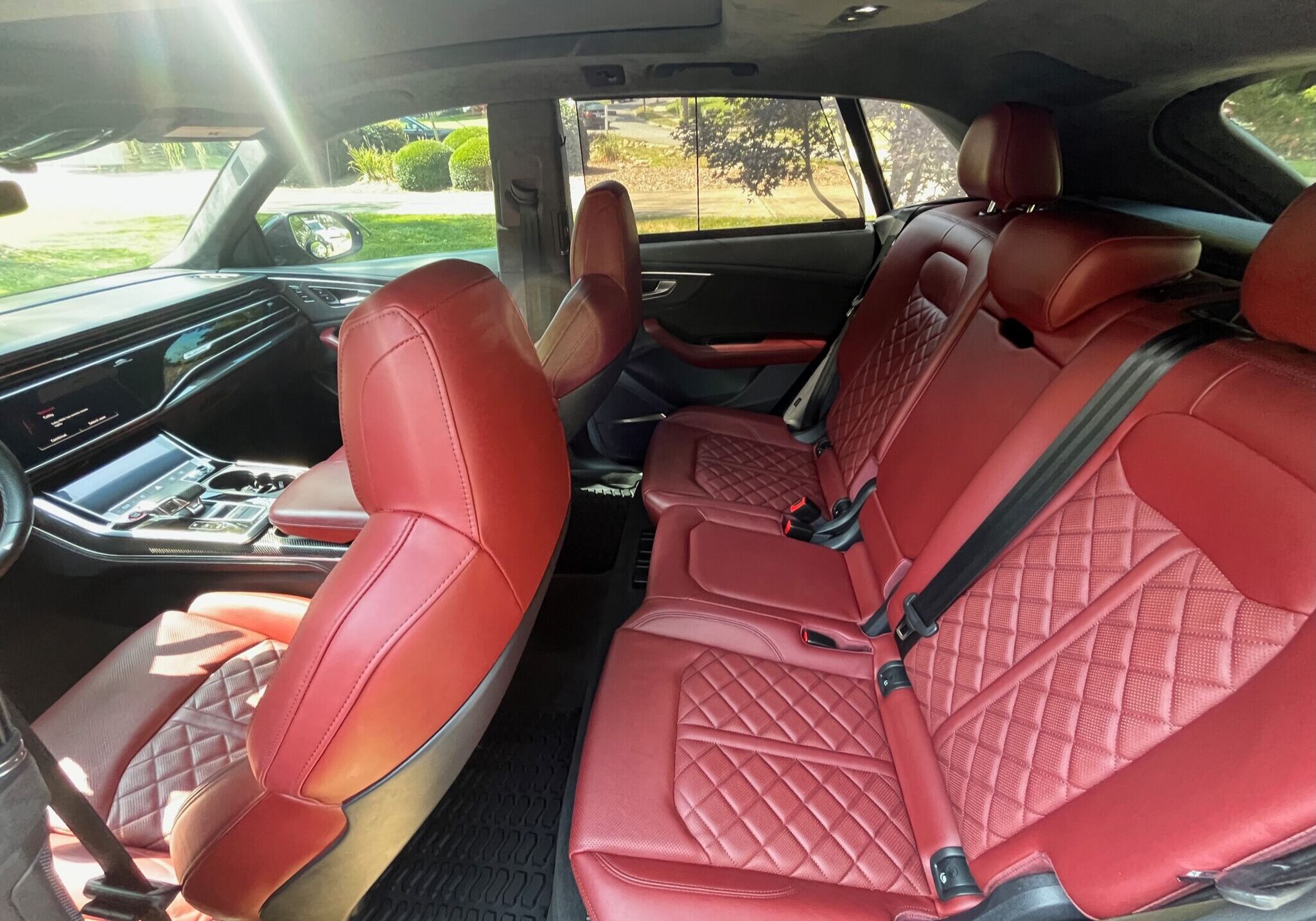 Red leather interior of a luxury car after applying Ceramic Coating in Lake Norman, showcasing enhanced durability and a premium finish.